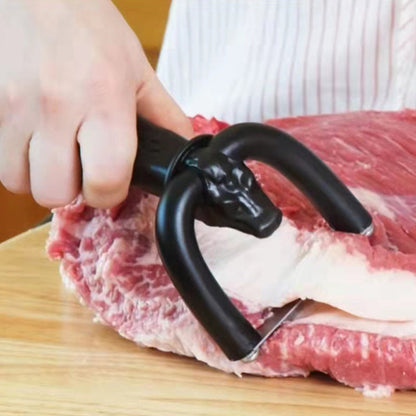Handheld trimming tool used on a piece of meat